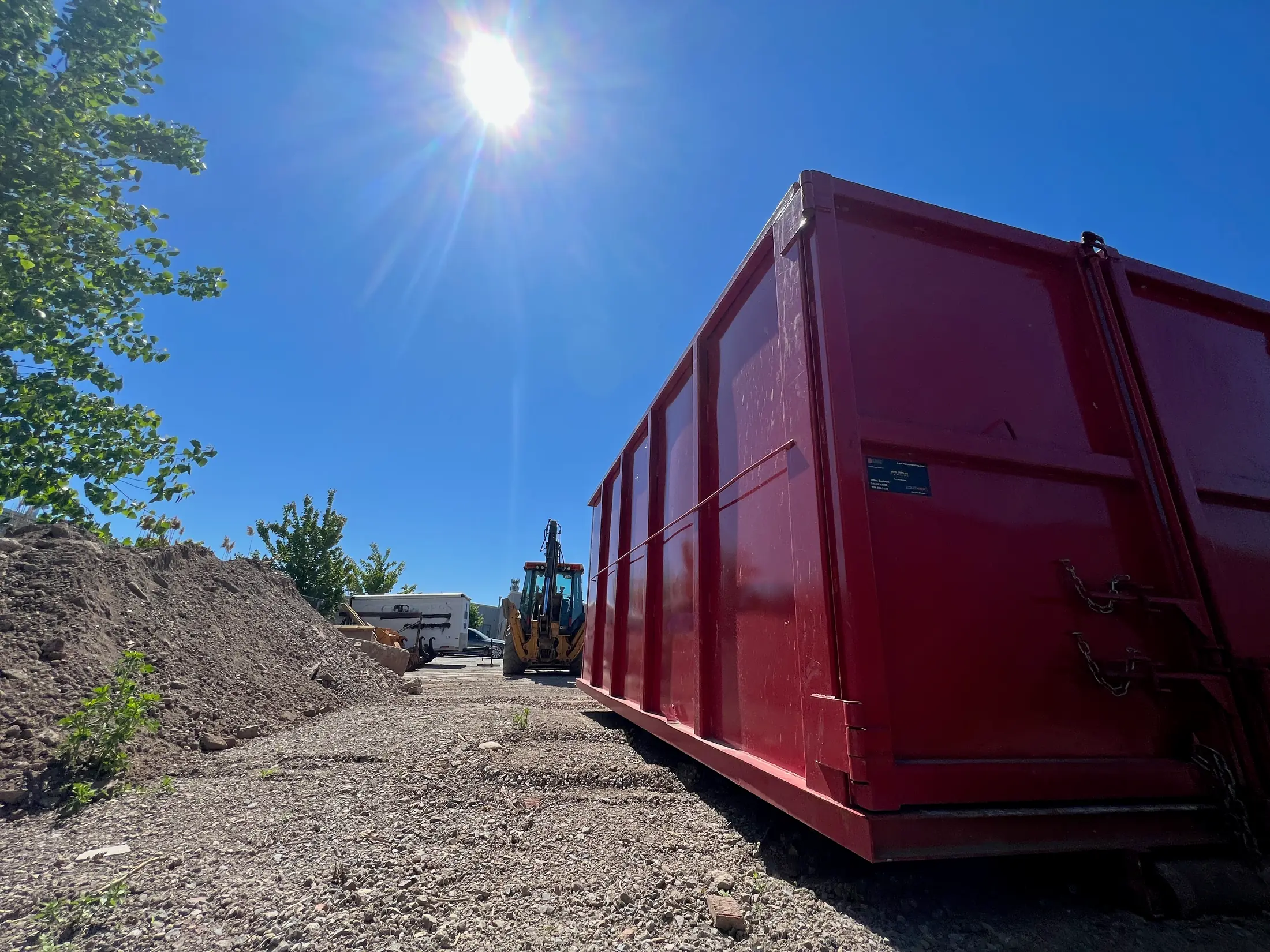 Red AG Disposal bin in a sunlit yard